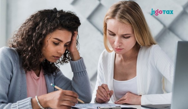 A J-1 Work & Travel visa holder reviewing tax documents to avoid common filing mistakes